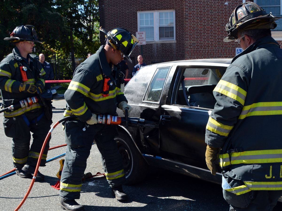 Firefighters Sawing Hole in a Car